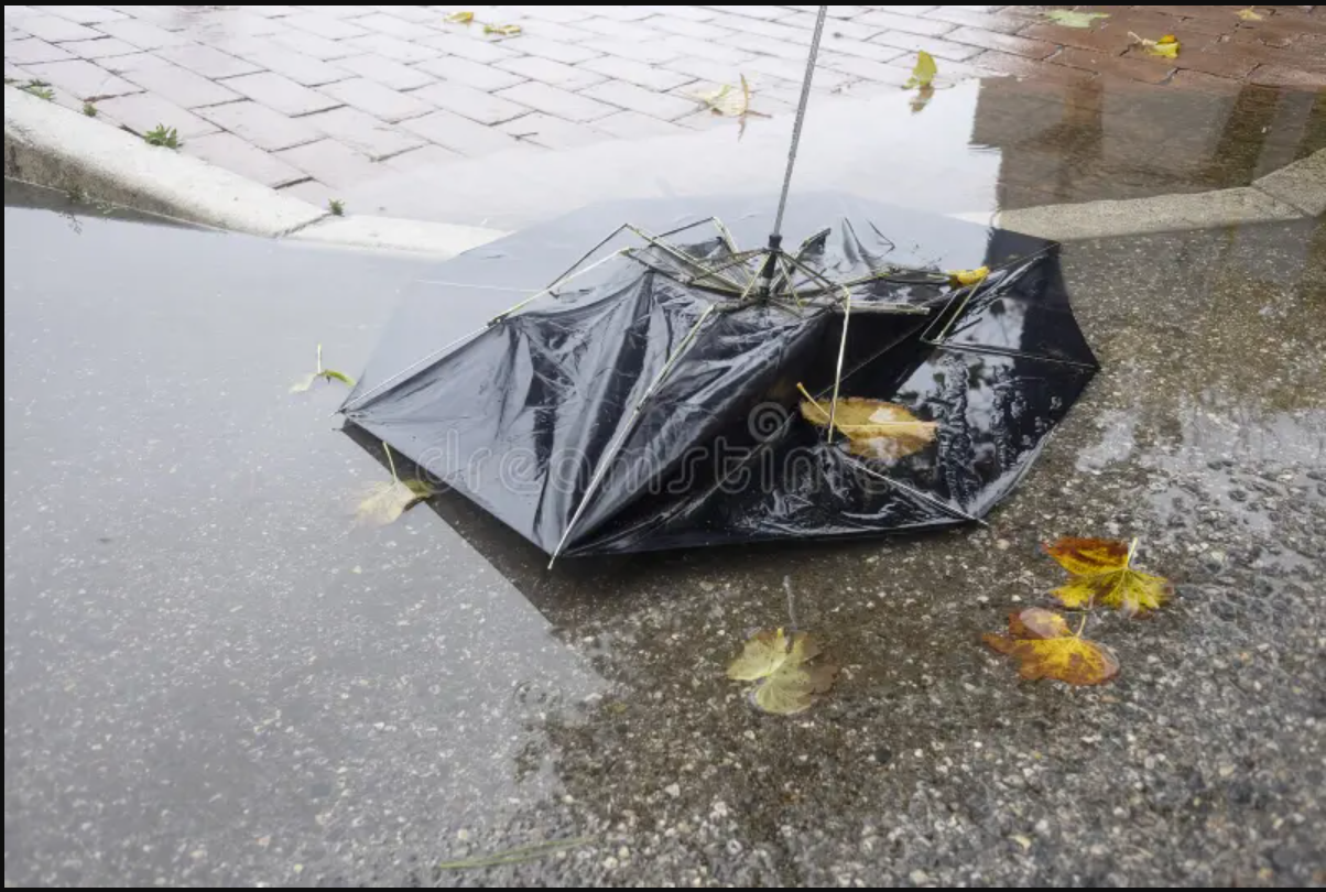 A navy QuickShut umbrella shown both open with mesh vent panels visible, and folded into its compact form.